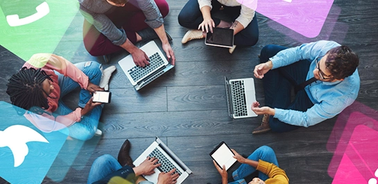 A diverse group of people collaborating on digital devices, with social media icons symbolizing the channels used in community management marketing.