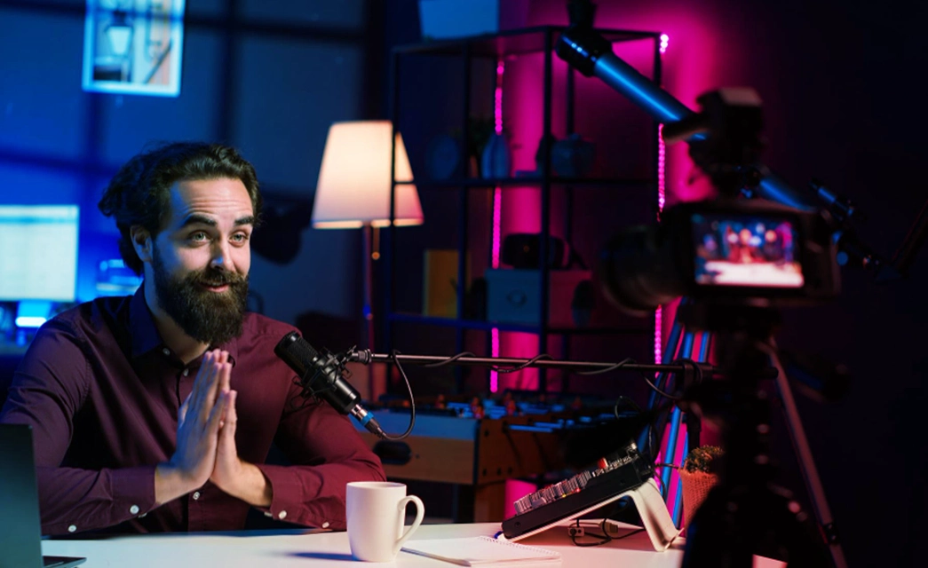 A content creator films a segment in a studio, a key part of executing a video marketing strategy.